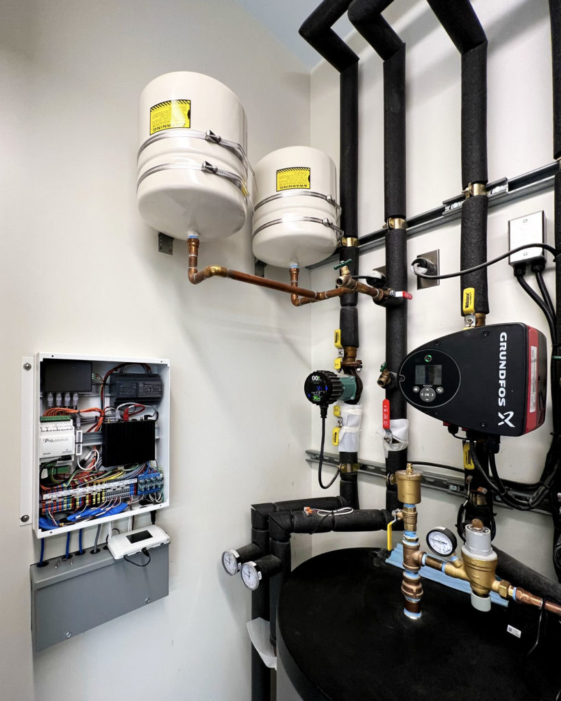 mBox hydronic controller in a mechanical room to manage radiant cooling and heating.