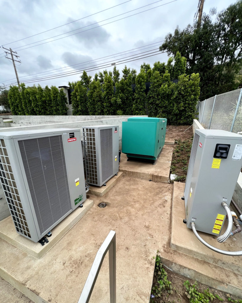 Three SpacePak heat pumps to generate hot and cold water for a radiant cooling and heating system managed via Messana Controls.
