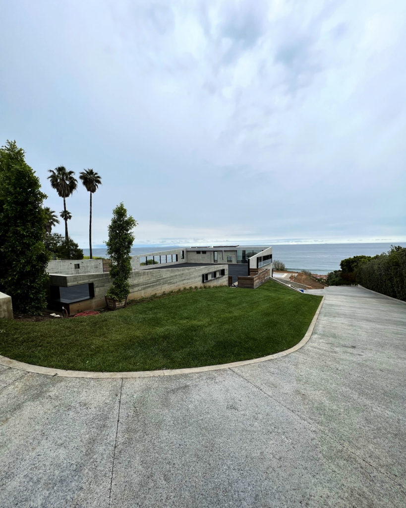 Exterior driveway view of Malibu home that utilizes a Messana Ray Magic® radiant ceiling system to provide radiant cooling and heating.