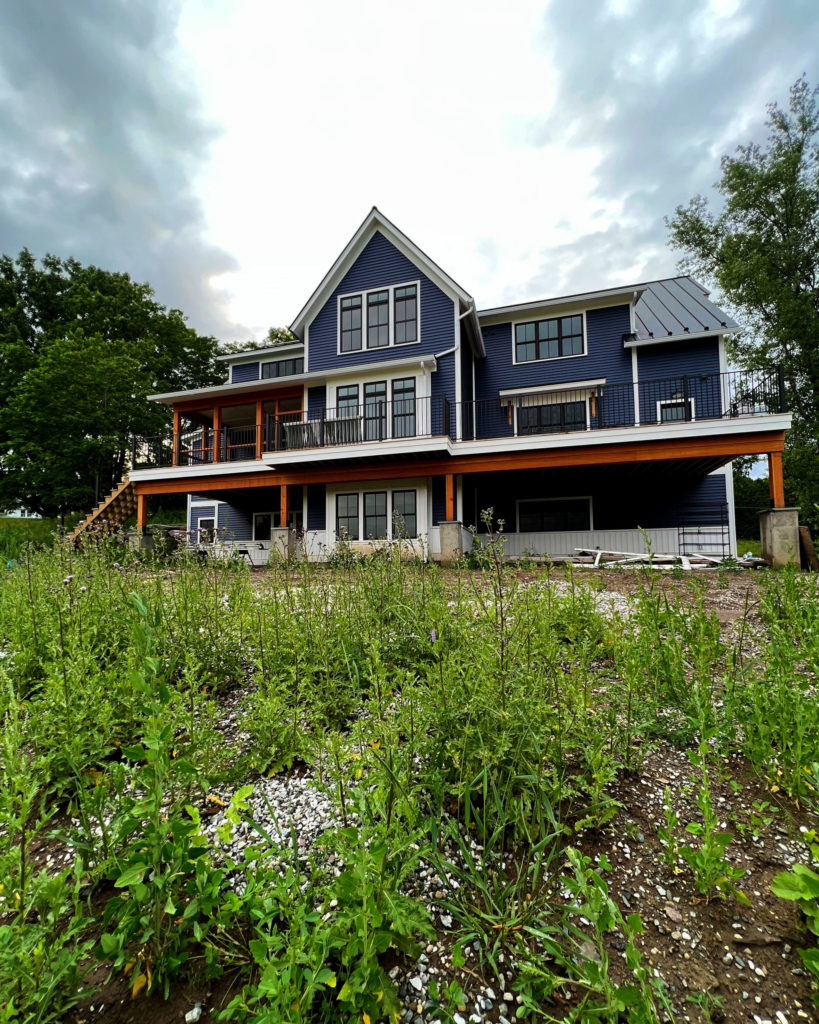 Exterior of home in Charlotte, Vermont, that utilizes a geothermal heat pump to provide hydronic heating and cooling.