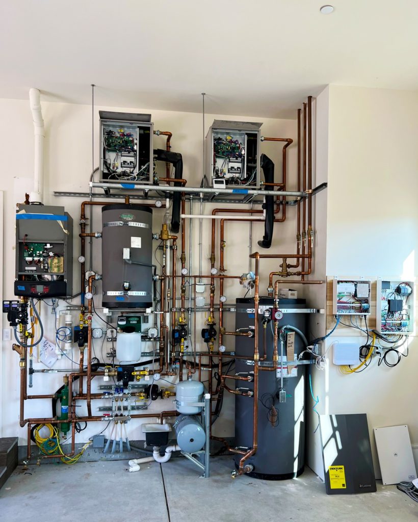 Mechanical room for hydronic heating and cooling and domestic hot water production.