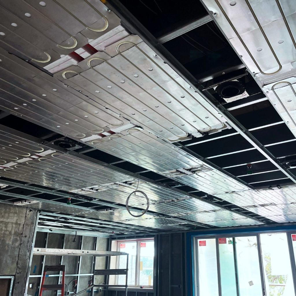 Ray Magic® NK radiant ceiling panels being installed for hydronic heating and cooling.